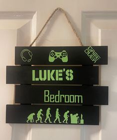 a wooden sign that says luke's bedroom and video game room hanging from a door