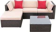 an outdoor sectional set with red pillows on it