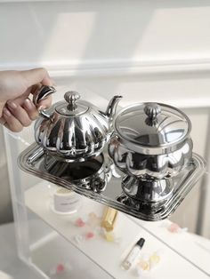 This beautiful tea set features a sleek, modern design and a polished finish. The teapot and sugar bowl are both adorned with intricate detailing, adding a touch of sophistication. Perfect for serving tea and sugar in style. Teapot Collection, Coffee Candy, Sugar Bowls, Coffee Service, Pendant Lights & Chandeliers, Sideboard Console, Tea Bowls, Tea Pot Set