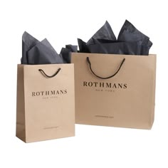 two brown paper bags with black handles and the words rothman's on them