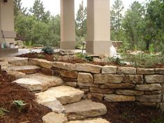 an outdoor area with stone steps and trees