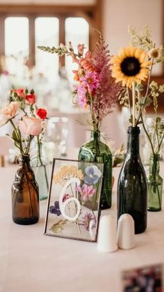 three vases filled with flowers on top of a table