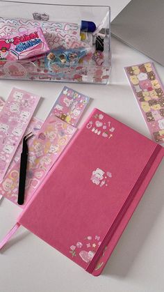 the contents of a hello kitty stationery set up on a white table with pens and pencils