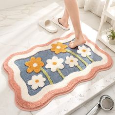 a woman standing on top of a bathroom rug