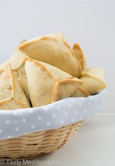 a basket filled with pita bread sitting on top of a table