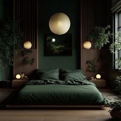 a bed with green sheets and pillows in a dark room next to potted plants