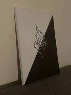 an arabic calligraphy is displayed on a canvas