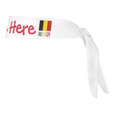 a white headband with the words here and belgium in red, yellow, and black