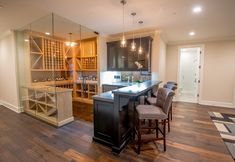 a kitchen with an island and wine rack in it