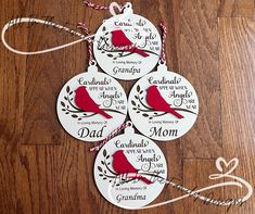 four personalized christmas ornament hanging on a wooden floor with string and twine