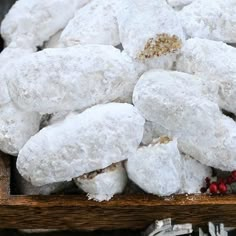 a pile of powdered sugar cookies sitting on top of a wooden table