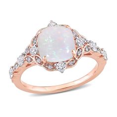 a white opal and diamond ring in rose gold with diamonds on the sides, set against a white background