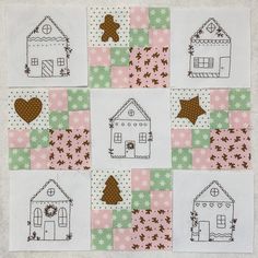 a patchwork quilt with small houses and stars on the squares in pink, green, brown and white