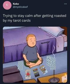 a man sitting on top of a bed next to a table with playing cards in front of him