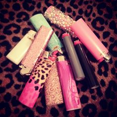 several different types of lighters on a leopard print surface with beads and pearls in them