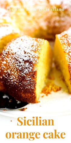 a close up of a cake with powdered sugar on top and the words sicilian orange cake below it