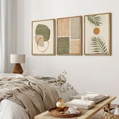 a bed room with a neatly made bed and two paintings on the wall