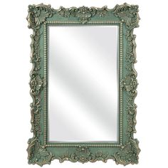 an ornate green framed mirror on a white wall