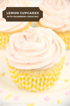 three cupcakes with pink frosting on a white and yellow polka dot plate