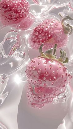 some pink objects are floating in water on a white tablecloth with bubbles around them