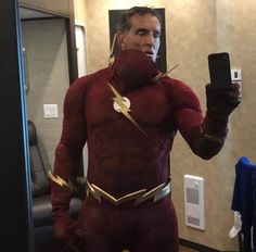 a man in a flash costume taking a selfie