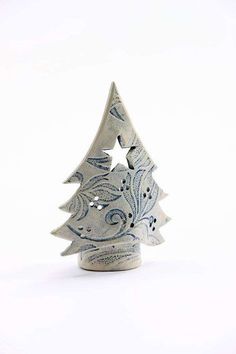 a small ceramic christmas tree sitting on top of a table