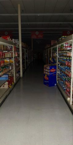 an empty grocery store aisle filled with lots of food