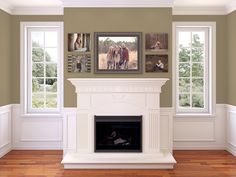 a fireplace in a living room with four pictures on the wall and one is holding a baby