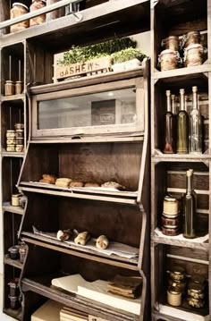 an old wooden shelf filled with lots of jars and other items on it's sides