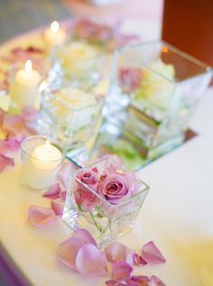 flowers and candles are arranged on a table