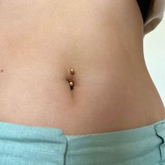 a woman's belly with tiny gold beads on her tummy and side view