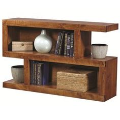 two wooden shelves with books and vases on them