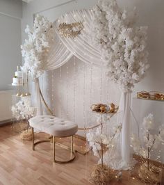 a room decorated with white flowers and gold accents