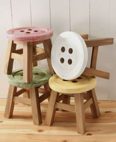 three wooden stools with buttons on them