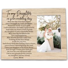 a wooden frame with an image of two brides and the poem for their daughter