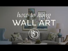 a living room with couches, chairs and pictures on the wall above it that says how to hang wall art