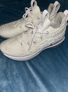 These are a steal! Selling on GOAT and StockX for well over $300-$400. Elevate your sneaker game with the Nike LeBron 15 Low in White Metallic Silver. This stylish and versatile sneaker features a low top shoe shaft style, making it perfect for both casual and athletic wear. The shoe boasts a sleek white and metallic silver colorway, with the iconic Nike LeBron logo adorning the side. Crafted with comfort and performance in mind, the Nike LeBron 15 Low is equipped with a breathable and durable design, making it ideal for any occasion. This sneaker is available in a men's US shoe size 10.5, and is part of the Nike LeBron product line. The shoe was released on April 2, 2018, and has a unique style code of AO1755-100. Elevate your style and game with the Nike LeBron 15 Low. Lightly worn and o Lebron Logo, Lebron 15 Shoes, Sneaker Games, Nike Lebron, Athletic Wear, Top Shoes, Low Top, Nike Shoes, Metallic Silver