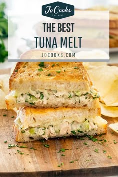 the best tuna melt sandwich is on a cutting board with chips