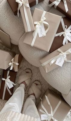 a person's feet are surrounded by wrapped presents