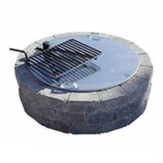 an outdoor fire pit with grills on the top and bottom part in grey stone