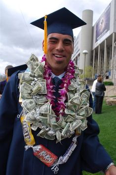 a man wearing a graduation cap and lei with money in it