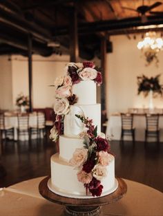 a white wedding cake with flowers on top