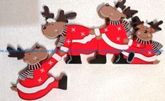 three christmas reindeers in red and white outfits