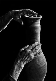 an old woman is making a vase with her hands on the potter's wheel