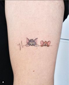 two kittens on the side of a woman's leg with heartbeat line tattoo