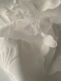 white fabric with flowers and leaves on it