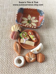 some food is laying out on the floor in front of a bowl and spoons