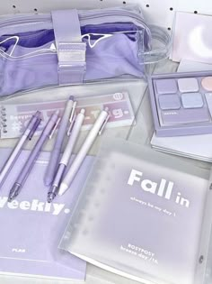 the contents of a purple bag are neatly organized and ready to be used for makeup