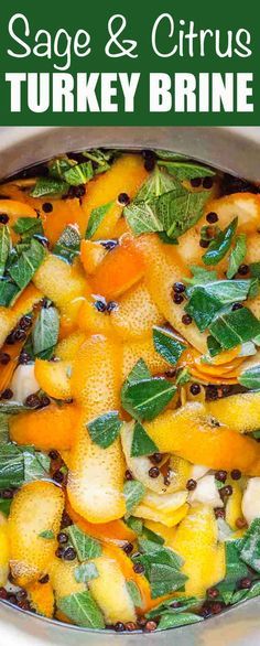 a bowl filled with oranges and green leaves