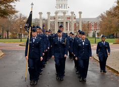 a group of air force personnel walking down the street